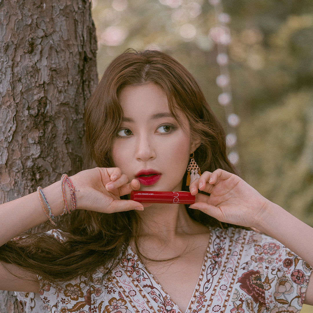 Lip tint in Cherry Bomb shade, moisturizing and shiny.